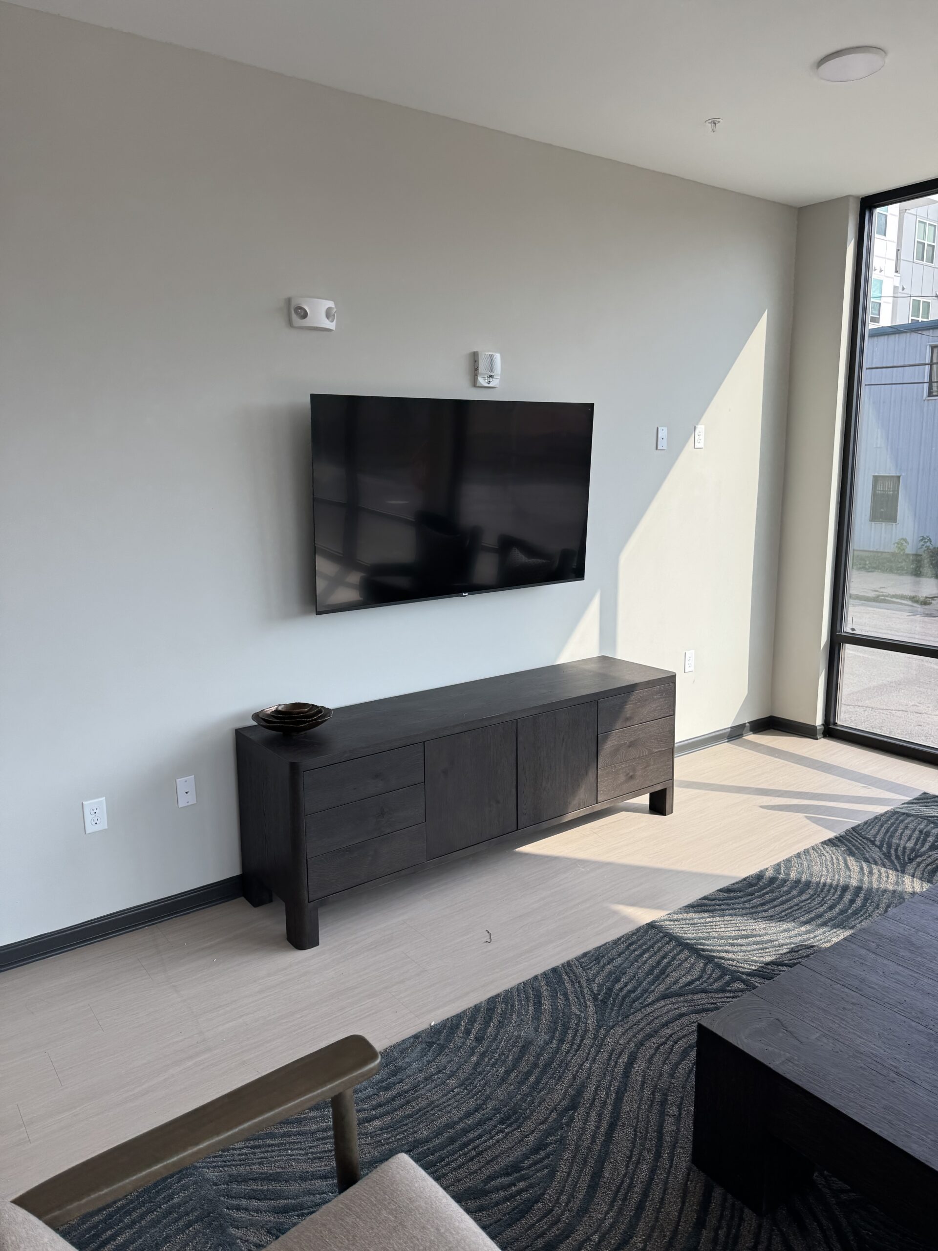Modern living room TV installation with organized hidden wiring in Houston