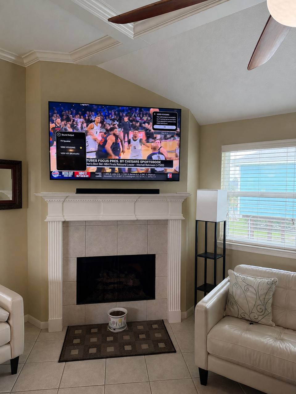 Above fireplace TV mounting with white built-ins in a Houston home