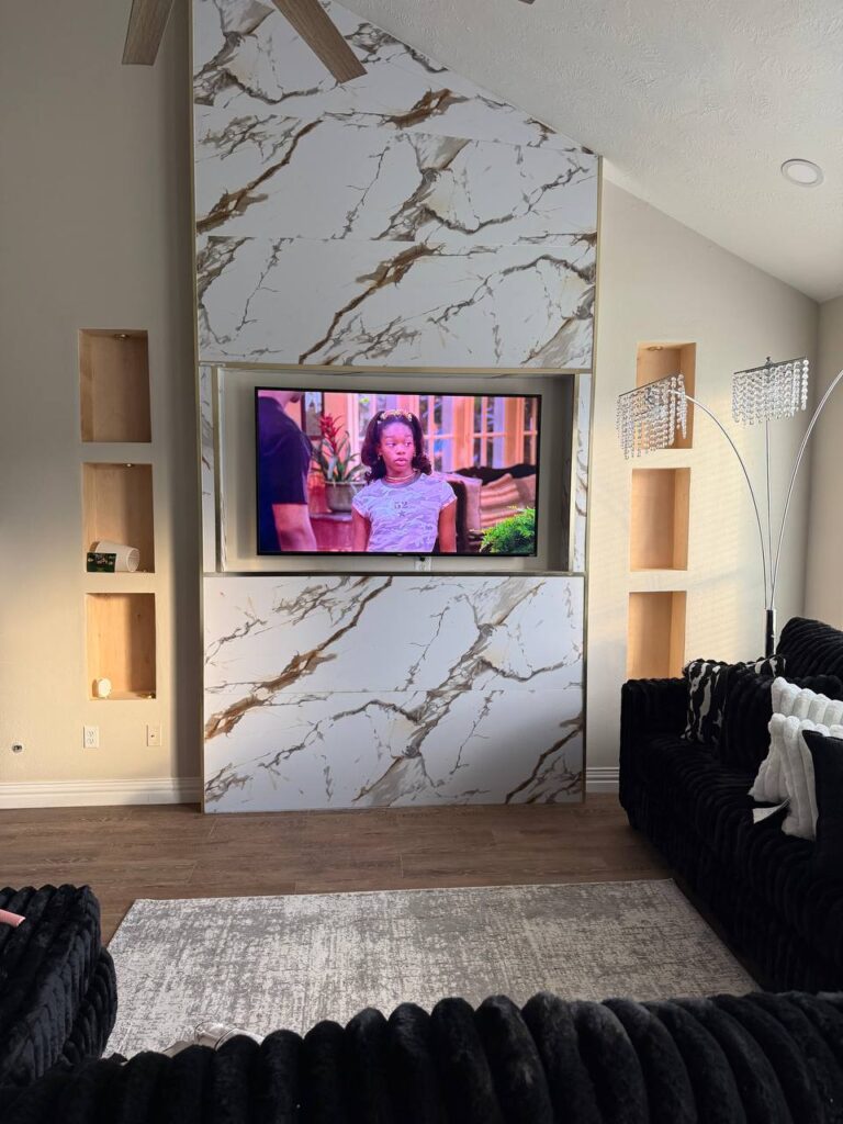 Modern marble wall TV mounting with clean built-in design in a Houston living room