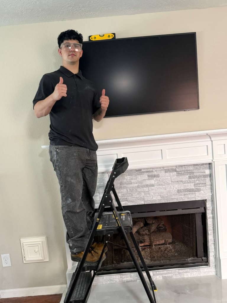 Carlos TV Mounting professional fireplace TV installation using precision tools in Houston