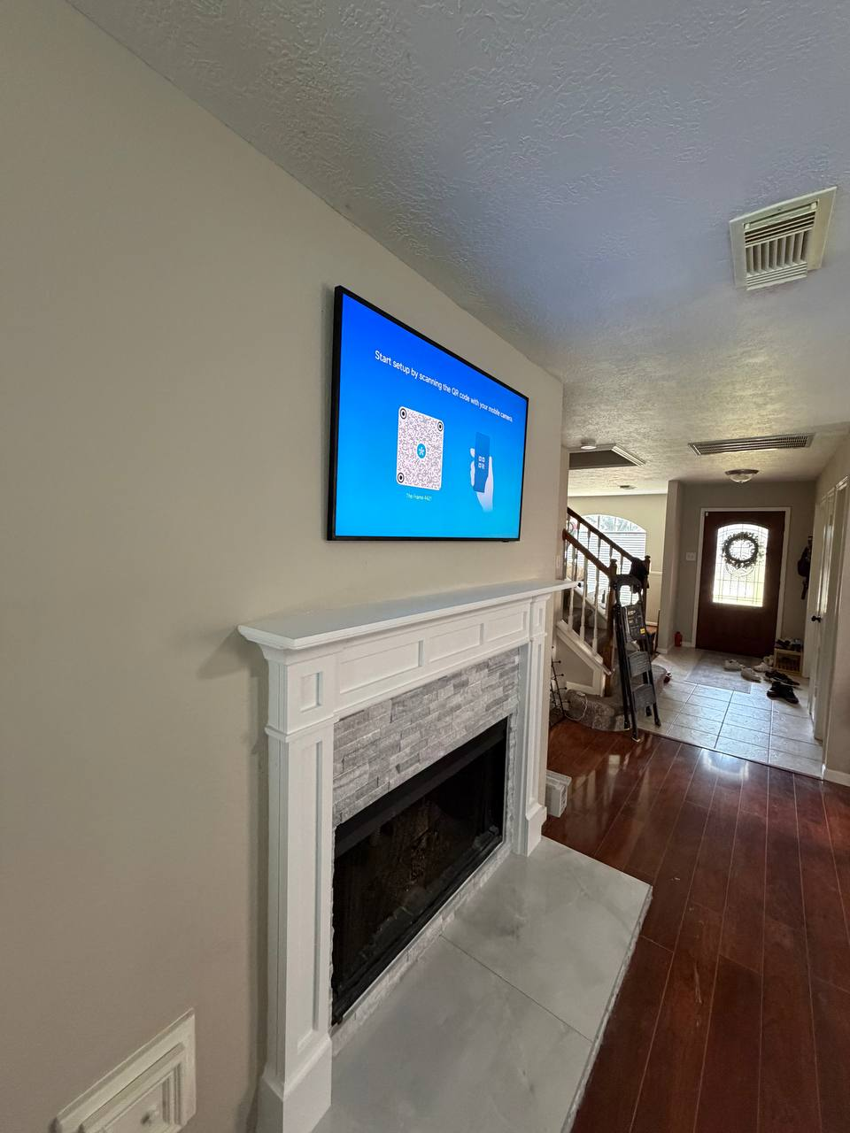 Home Angled fireplace TV mounting installation with clean finish in Houston