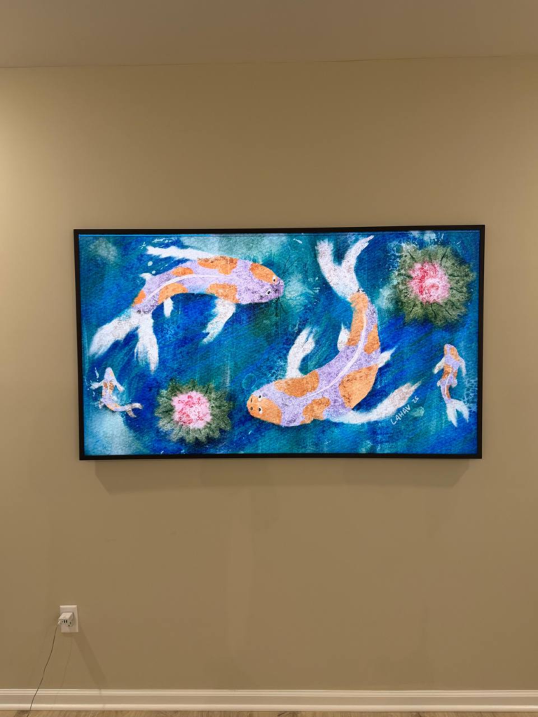 Wall mounted TV displaying koi fish artwork in a Houston home
